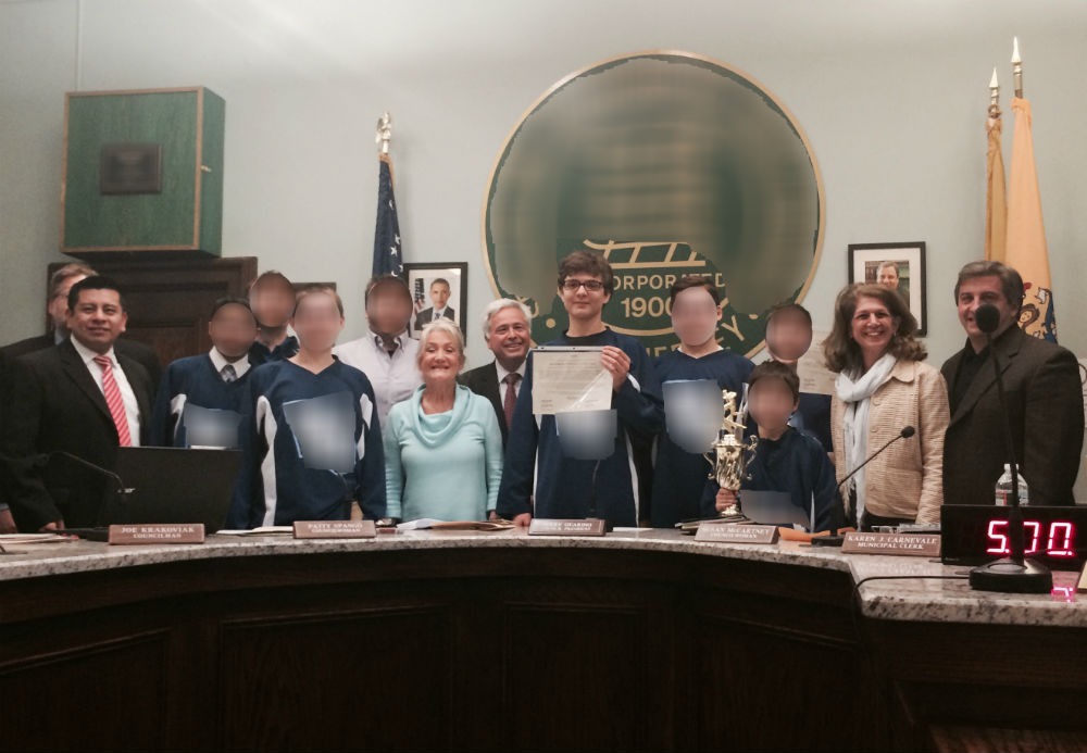 Ryan poses with the certificate, his teammates and coaches, and the mayor and town council members. (Note - I have blurred the faces of the other children and coaches.)